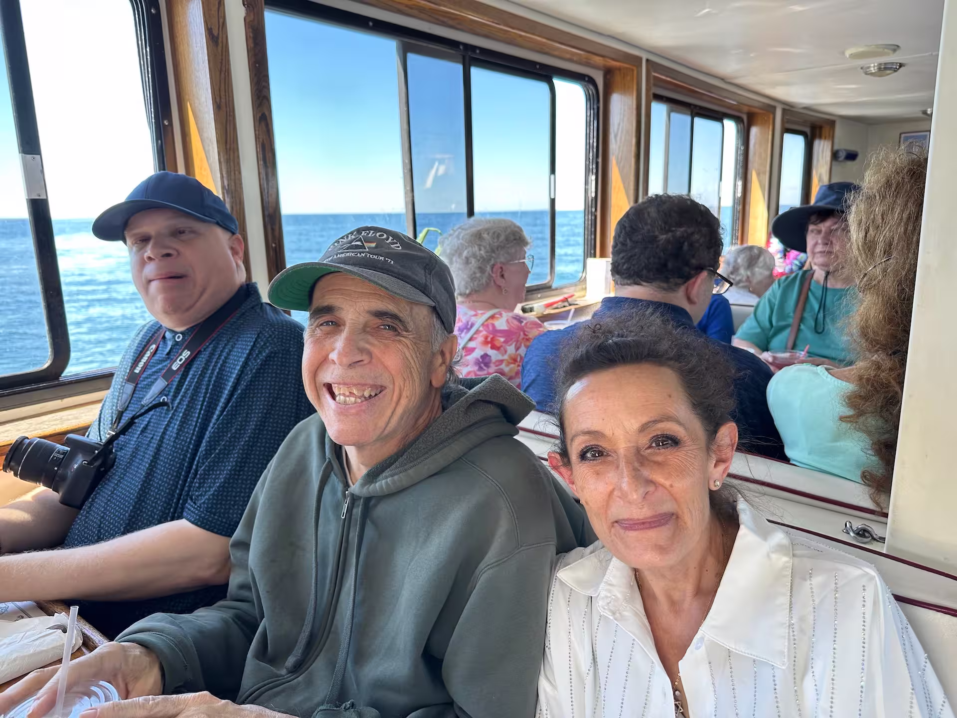Three people sitting at a table smiling.