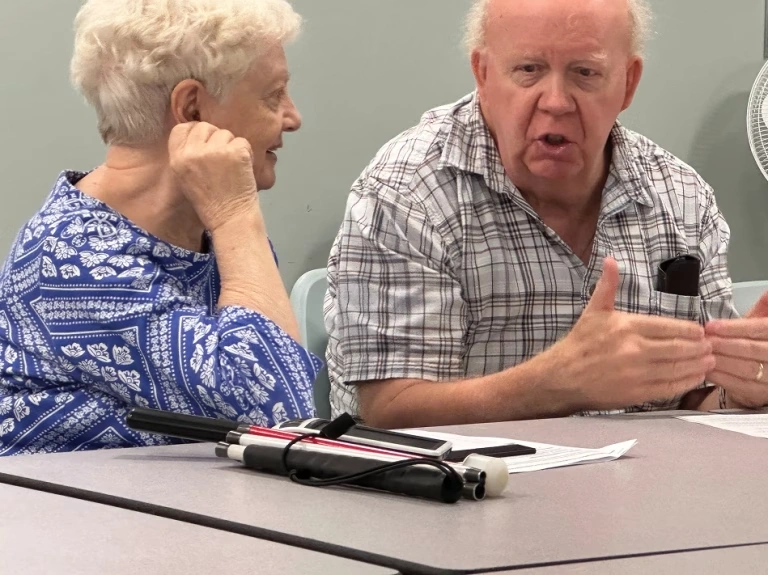Two people sitting at a table having a discussion.